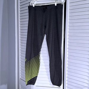 Oiselle Women’s grey causal joggers with green stripes.